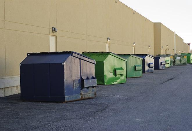 construction site debris being cleared away by dumpsters in Austin, AR